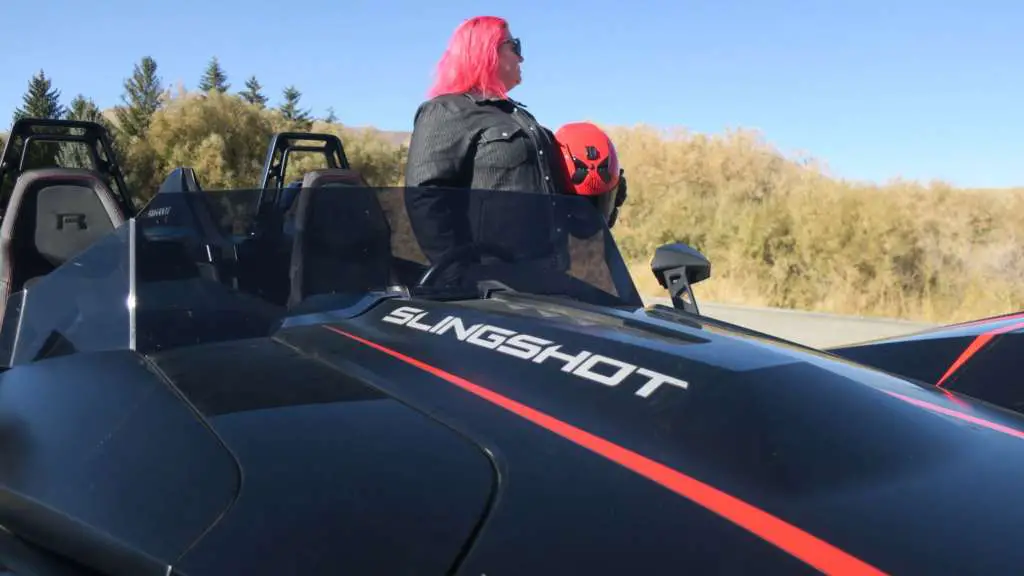Staff writer Carrie Leaverton stands next to the Slingshot, her full-face helmet in hand.